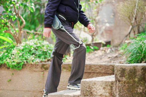 A person climbing steps wearing a leg exoskeleton